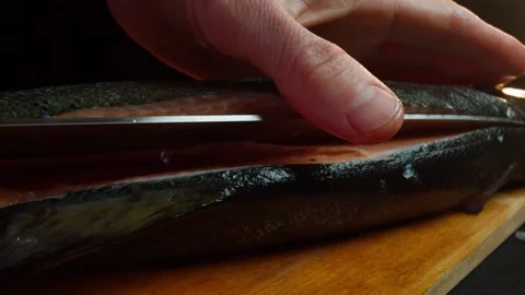 Close up hands of chef cook craving fish in slow motion in a dark kitchen Video stock 153206721