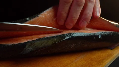 Close up hands of chef cook craving fish in slow motion in a dark kitchen Video stock 153206737