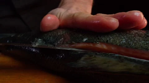 Close up hands of chef cook craving fish in slow motion in a dark kitchen Video stock 153206740