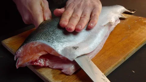 Close up hands of chef cook craving fish in slow motion in a dark kitchen Video stock 153206748