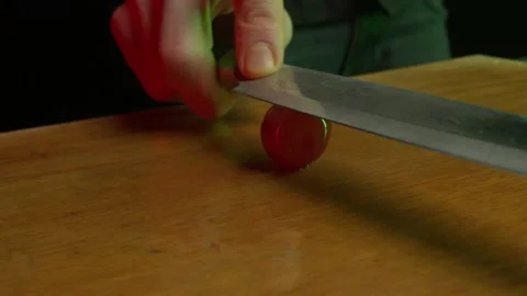 Close up hands of chef cook cutting grape in slow motion in a dark kitchen Video stock 153206654