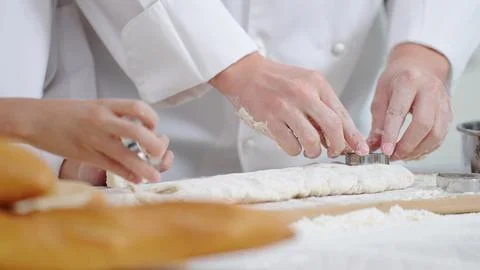 Close up hands of chef cooking, baking Press the stainless steel mold onto dough 스톡 사진