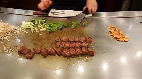 Close up hands of chef cutting vegetable(side dish)and spoon out beef steak Stock Footage 110907689