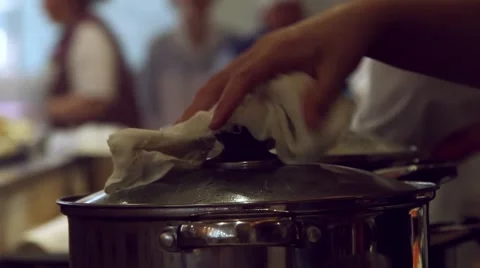 Close up of hands chef opens the pot filling pan with water and close the lid at Stock Footage 49117702
