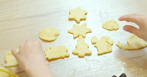 Close-up of the hands of a child preparing curly cookies from the dough Stock Footage 131452670