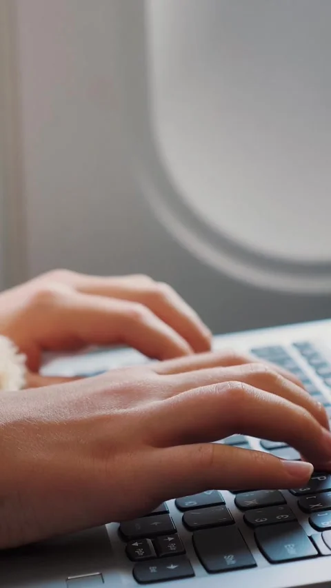 Close-up of hands, child is typing on a laptop keyboard, inside an airplane, Stock Footage 322109555