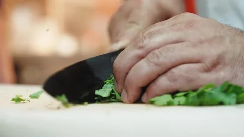 Close Up of Hands Chopping Fresh Herbs on a White Board Stock Footage 348330130