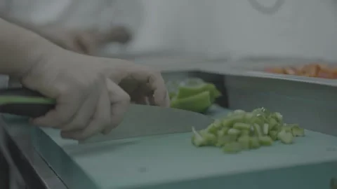 Close up of hands chopping fresh vegetables in commercial kitchen Stock-Footage 327069281