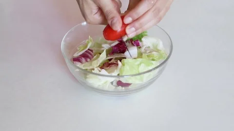 Close up of hands chopping some tomatoes and throwing them into a salad bowl Stock Footage 111592018