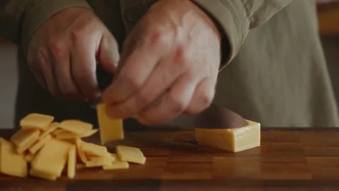 Close-up of hands chopping yellow cheese Video stock 320137594