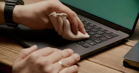 Close-up of Hands Cleaning Laptop Keyboard with Microfiber Cloth Stock Footage 308357008