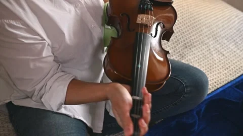 Close-up of hands cleaning a violin with a soft cloth Stock Footage 289588339