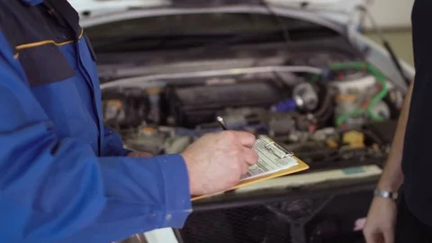 Close up of hands client of repair car service is giving keys to car mechanic Stock Footage 74609467