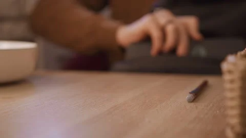 Close up hands closing notebook cover on wooden table with pen nearby in warm Stock Footage 345732275