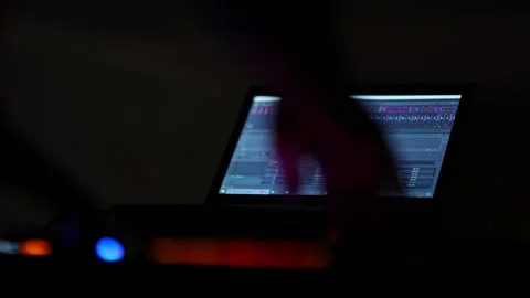 Close-up of hands controlling DJ mixer faders during a vibrant club party c.. Video stock 331790292