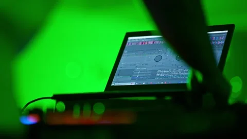 Close-up of hands controlling DJ mixer faders during a vibrant club party c.. Video stock 331790447