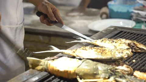 Close-up of hands, a cook prepares fish for grill. Stock Footage 122180293