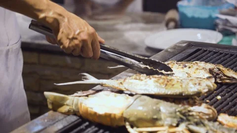 Close-up of hands, a cook prepares fish for grill. Stock Footage 122180446