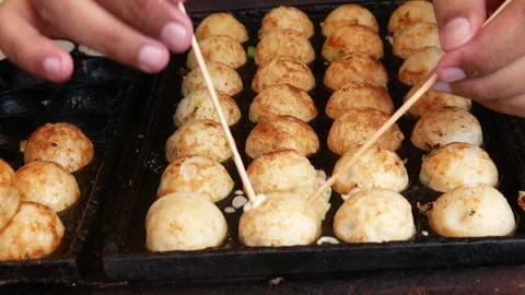 Close-up of hands cooking Takoyaki Stock Footage 302382976