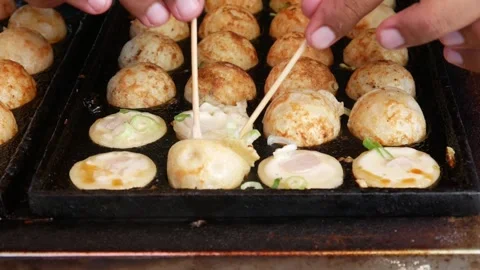 Close-up of hands cooking Takoyaki Stock Footage 302383064