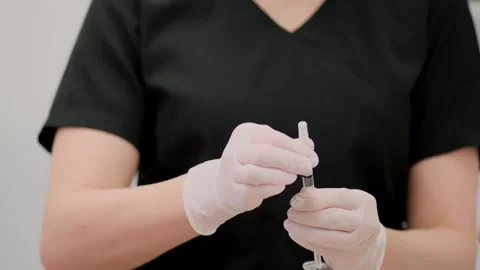 Close-up of the hands of a cosmetologist who is preparing for injection Stockbeeldmateriaal 263963544