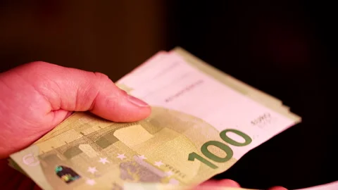Close-Up of Hands Counting 100 Euro Banknotes 動画素材 338186079