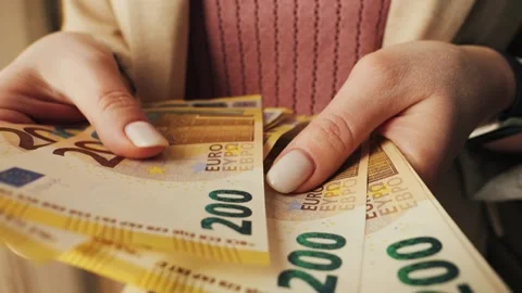 Close-up of hands counting 200-euro bills. Paying with European banknotes Stock Footage 328306905