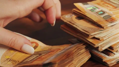Close-up of hands counting 50 euro notes. Stacks of money are thrown on the 스톡 동영상 318747422
