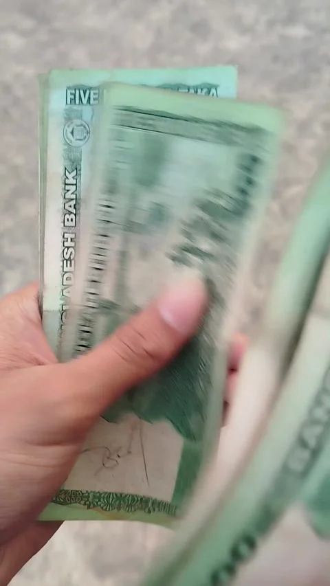 Close-up of hands counting 500 taka notes on March 07, 2026 in Bangladesh Stock Footage 330315876