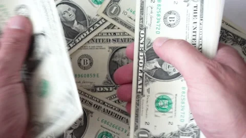 Close-up of hands counting dollar bills at table. Stock Footage 138533178