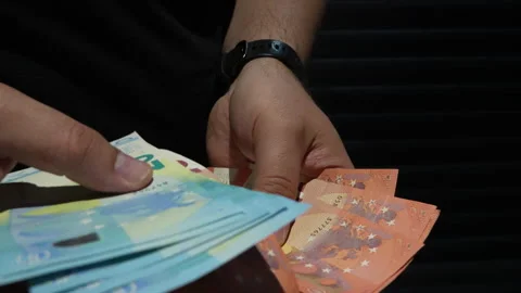 Close Up Of Hands Counting Euro Banknotes In Dark Setting Stock Footage 339967022