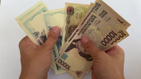 Close-up of hands counting Indonesian Rupiah Stock Footage 312587689