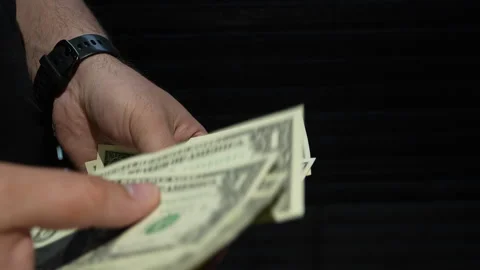 Close Up Of Hands Counting One Dollar Bills On Black Background Stock Footage 339967164