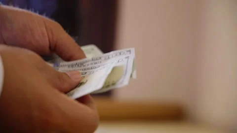 Close-Up of Hands Counting One Hundred Dollar Bills Stock Footage 318241997