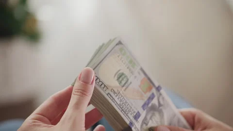 Close-up of hands counting a stack of 100 US dollar bills Stock Footage 284240580