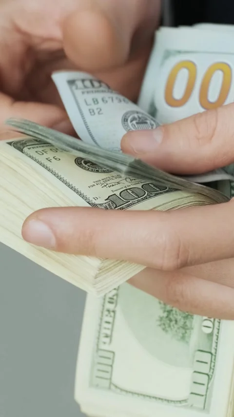 Close up of hands counting stack of hundred dollar bills. Wealth and cash flow. Stock Footage 331424546