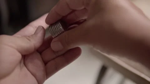 Close up of hands counting stacked Mexican coins for cash payment and financial Stock Footage 343805710