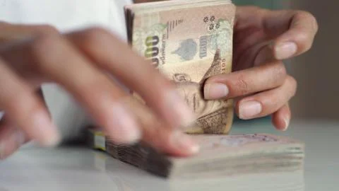 Close up hands counting of thousansds Thai baht money.Close up Human counting Stock Photos
