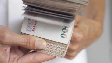 Close up hands counting of thousansds Thai baht money.Close up Human counting Stock Photos