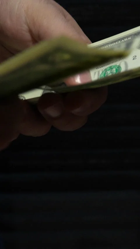 Close Up Of Hands Counting Two Dollar Bills On Black Background Stock Footage 339971624