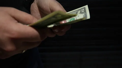 Close Up Of Hands Counting Two Dollar Bills On Black Background Stock Footage 339972190