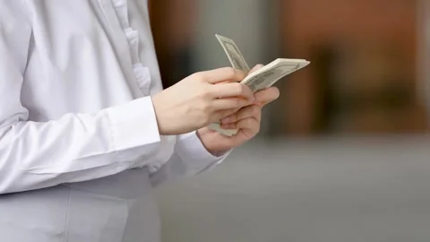 Close-Up of Hands Counting US Dollar Bills and Cash for Financial Transaction Stock Footage 319192007
