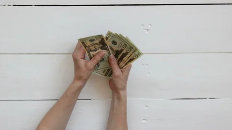 Close-Up Of A Hands counts the dollar bills and take them Stock Footage 129293801