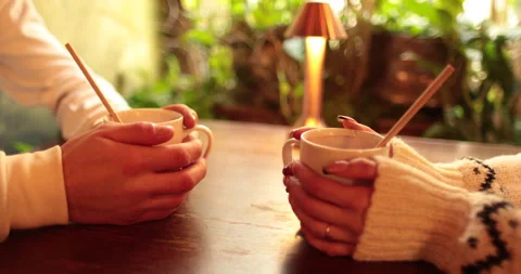 Close-up of the hands of a couple in love sitting at a table in a cafe Stock Footage 247001372