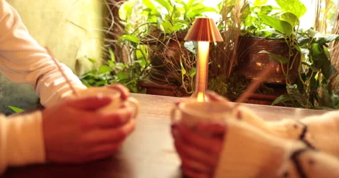 Close-up of the hands of a couple in love sitting at a table in a cafe Stock Footage 247001413