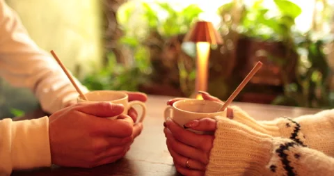 Close-up of the hands of a couple in love sitting at a table in a cafe Stock Footage 247001463