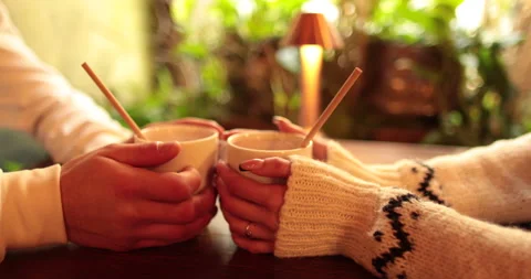 Close-up of the hands of a couple in love sitting at a table in a cafe Stock Footage 247001528