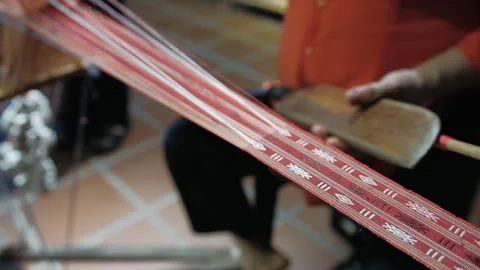 Close up of hands crafting a fabric using an old handloom. Traditional text.. Stock Footage 336978863