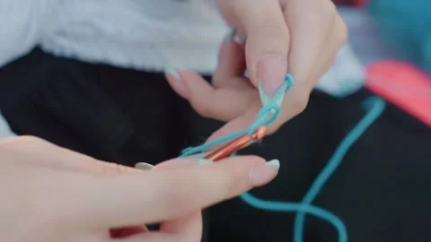 Close up hands crocheting blue yarn with copper hook detailed crochet technique Video stock 345841721