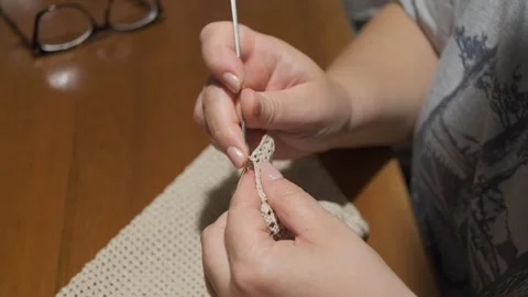 Close-up of Hands Crocheting with Light Yarn and Hook Stock Footage 342559107